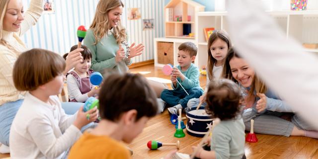 Parents taking part in the activities for preschool children. Healthy learning environment. Teacher and parents working together.