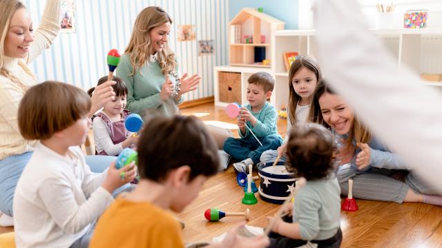 Parents taking part in the activities for preschool children. Healthy learning environment. Teacher and parents working together.