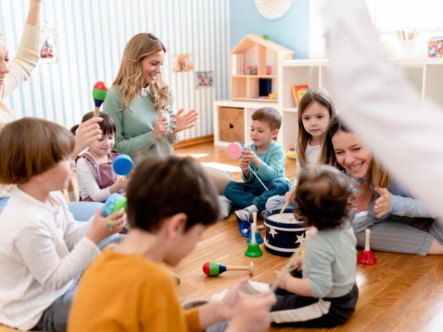 Parents taking part in the activities for preschool children. Healthy learning environment. Teacher and parents working together.