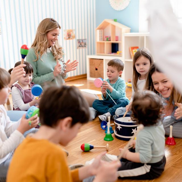 Parents taking part in the activities for preschool children. Healthy learning environment. Teacher and parents working together.